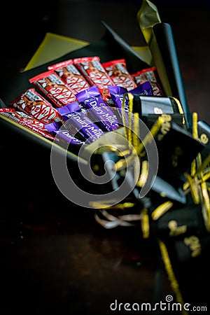 Cadbury Dairy Milk and Kit Kat, chocolate candies and flowers in sweet bouquet as gift for celeb Editorial Stock Photo