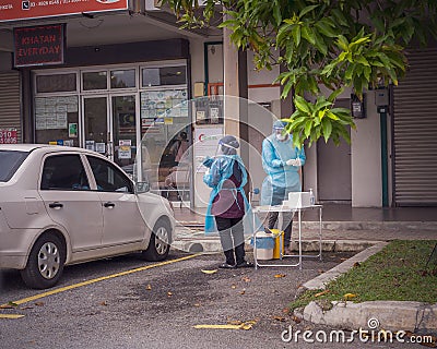 Health worker performing COVID-19 sampling taken from individuals by drive thru at the Quick Test Editorial Stock Photo
