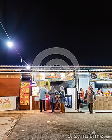 People at the Nasi Lemak stall called Nasi Lemak Nek Jai buying dinner Editorial Stock Photo