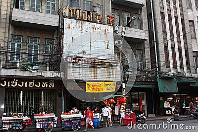 Bangkok Chinatown. Big old house. Fruit trade with carts. Red lanterns Editorial Stock Photo