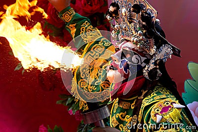 Bangkok Chinese New Year, Chinese Opera actor perform spitting fire in the traditional face-changing. Stock Photo