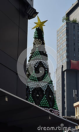 Bangkok has a Christmas season, which has large pine trees set between two buildings Stock Photo