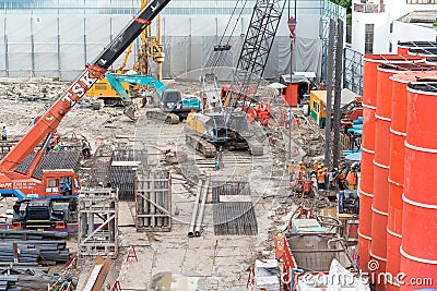 Bangkok, Thailand: machines and workers in SEAFCO uniform work on construction site of O-Nes Tower Editorial Stock Photo