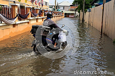 BANGKOK - May 25: A people evacuates from the flooded area at Ba Editorial Stock Photo