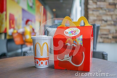 BANGKOK - OCTOBER 10, 2 : Happy meal set ,in soft focus, with blurred Ronald Mcdonald at McDonald`s restaurant on October 10, 2017 Editorial Stock Photo