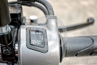 BANGKOK, THAILAND - APRIL 03, 2019: Idling Stop Switch For Eco Mode on a 2019 Honda Scoopy i Club 12 Motor Scooter Editorial Stock Photo