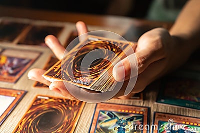 A man playing Yu-Gi-Oh trading card game. Editorial Stock Photo