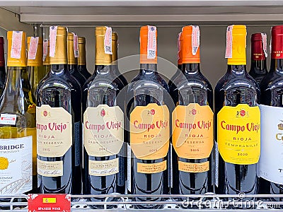 Many bottles of Wines on the shelf for sale Editorial Stock Photo