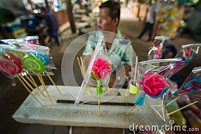 Bangkok, Thailand - April, 16, 2023 : Molding traditional art candy from sugar with food colorant at Taling Chan Floating Markett Editorial Stock Photo