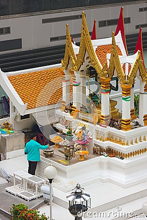 Bangkok, Thailand - April 31, 2014. Man making an offering at Amarindradhiraja shrine in the city of Bangkok Editorial Stock Photo