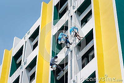 Painter climbing the building to painted at wall Editorial Stock Photo