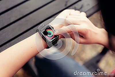 Bangkok, Thailand - April 03, 2018 : woman touch screen on checking activity app on Apple Watch. Editorial Stock Photo