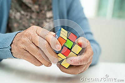 Bangkok, Thailand August 14, 2023 Alzheimer disease AD, Asian elderly woman patient playing Rubik cube game to practice brain Editorial Stock Photo