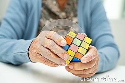 Bangkok, Thailand August 14, 2023 Alzheimer disease AD, Asian elderly woman patient playing Rubik cube game to practice brain Editorial Stock Photo