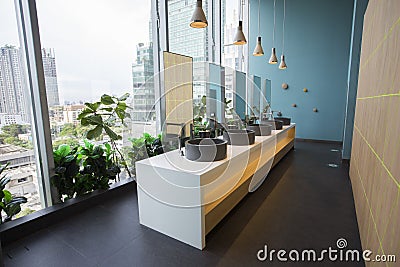 Bangkok, Thailand - August 7, 2020: black floor green blue wall of modern lavatory rooms with black washbowls and hanging lights Editorial Stock Photo