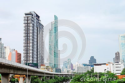 BTS or Bangkok skytrain line with Office building or Residence. View from Krung Thon Buri station Editorial Stock Photo