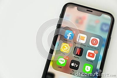 Bangkok, Thailand - August, 2020 : iPhone X on the table and show display app Social media screen. Editorial Stock Photo