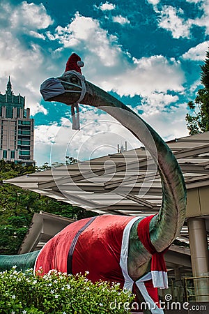 Christmas decorated Dinosaur sculpture at the entrance of BDMS Wellness Clinic Editorial Stock Photo