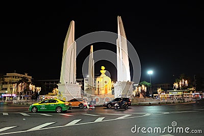 Democracy Monument located at the intersection of the streets of the night city. Street Editorial Stock Photo