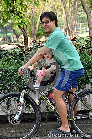 Bangkok, Thailand: Father with Toddler on Bike Editorial Stock Photo