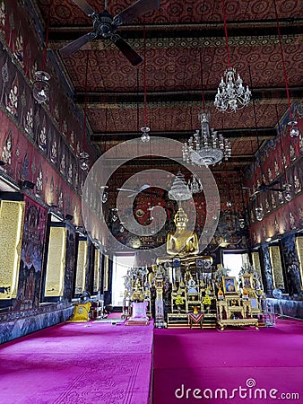 Golden Buddha statue in the Phra Ubosot of Wat Saket Editorial Stock Photo