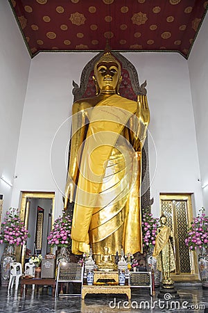 Standing golden Buddha statue in Wat Pho, Bangkok Editorial Stock Photo