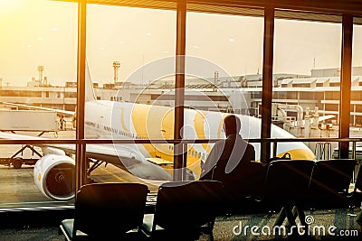 Tourist man are reading books to waiting for the air plane beside the airport terminal Editorial Stock Photo