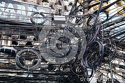 Chaos of cables and wires on an electric pole. Many electrical cable - wire and telephone Editorial Stock Photo