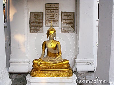 Golden Buddha image in a Thai Royal Family Mausoleum in the Royal Cemetery of Wat Ratchabophit temple in Bangkok Editorial Stock Photo