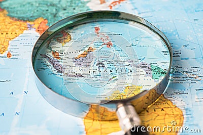 Bangkok, Thailand January 20, 2022 Indonesia, Magnifying glass close up with colorful world map, travel, geography, tourism and Editorial Stock Photo