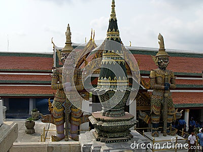 Sculptures of two great mythological warriors next to a stupa of the Royal Palace in Bangkok Editorial Stock Photo