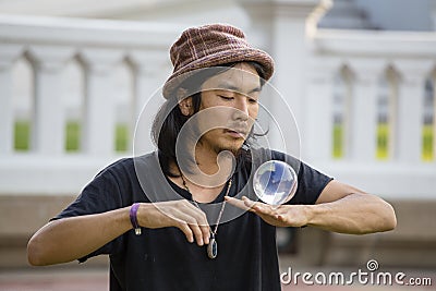 Street performer man juggling glass bowl in front of passers-by on the street Khao San Road in Bangkok , Thailand Editorial Stock Photo