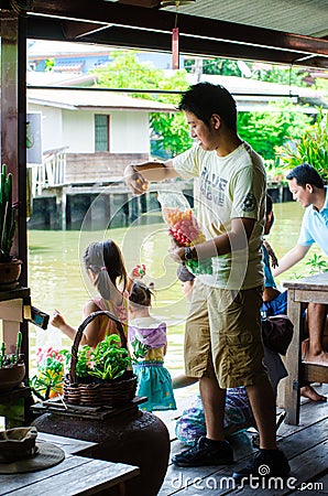 Bangkok, Thailand : Japanese tourists are feeding fish Editorial Stock Photo