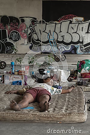 Homeless girl is sleeping in the abandoned building Editorial Stock Photo