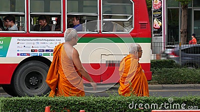 BANGKOK, THAILAND - 13 JULY, 2019: Buddhist holy Monk in traditional orange robe on the steet. Monks yellow religious clothes Editorial Stock Photo