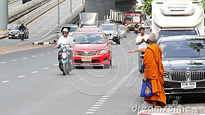 BANGKOK, THAILAND - 13 JULY, 2019: Buddhist holy Monk in traditional orange robe on the steet. Monks yellow religious clothes Editorial Stock Photo