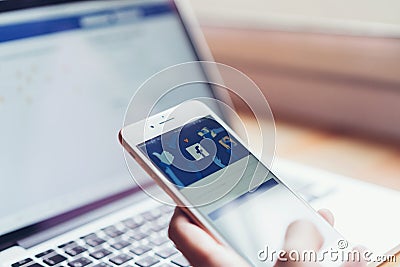 Bangkok, Thailand - July 24, 2018 : hand is pressing the Facebook screen on apple iphone6. Editorial Stock Photo