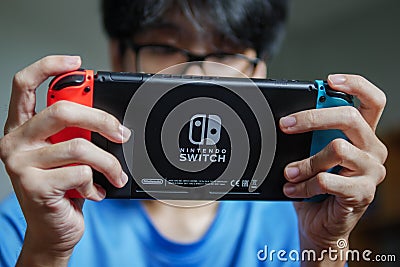 A man playing Nintendo Switch Editorial Stock Photo