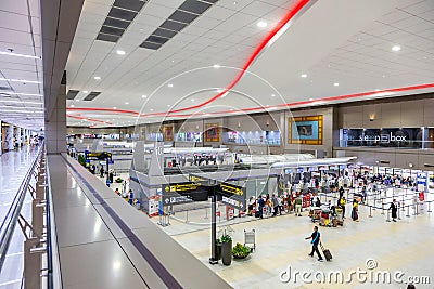 Passengers wait in line to check in their flight at Don Muang International Airport check in counters in Bangkok, Thailand Editorial Stock Photo