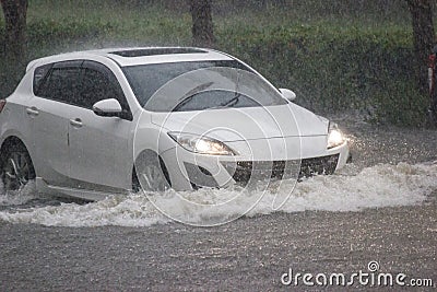 Car driving flood water, it`s raining heavily hard, Some of the flooded Editorial Stock Photo