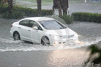 Car driving flood water, it`s raining heavily hard, Some of the flooded Editorial Stock Photo