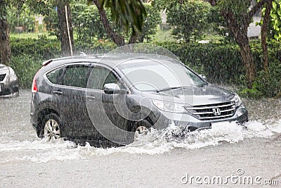 Car driving flood water, it`s raining heavily hard, Some of the flooded area is flooded Editorial Stock Photo