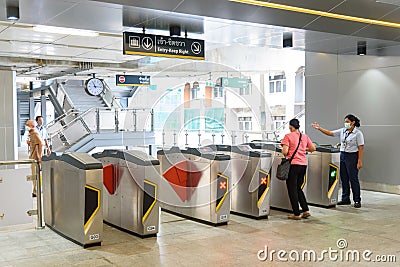 People enter the door gate for passenger Thai electric monorail train yellow line Editorial Stock Photo