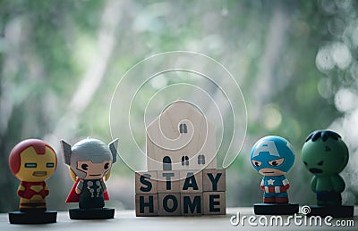 Bangkok, Thailand - June 10, 2020: Superhero with miniature wood home. Concept of hero at home Editorial Stock Photo