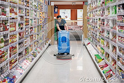 BANGKOK, THAILAND - JUNE 16: Unnamed Foodland supermarket employee cleans the floor with a machine in Bangkok on June 16, 2019 Editorial Stock Photo