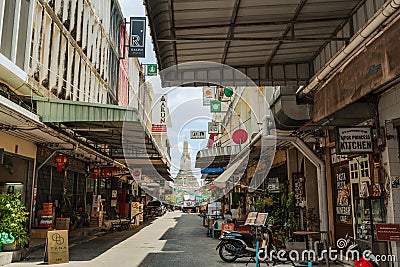 Wat Arun temple and local cafe restaurant street in Bangkok, Thailand Editorial Stock Photo