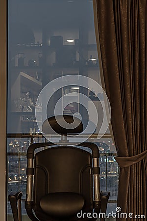 Comfort chair in Living room and City view at home, condominium in the evening Editorial Stock Photo