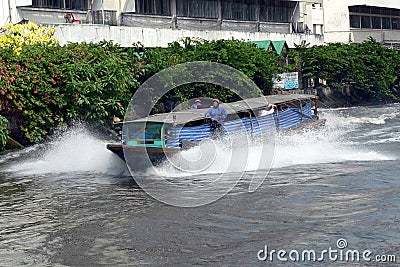 BANGKOK, THAILAND- MAR 1ST: A river taxi speeding along the San Editorial Stock Photo