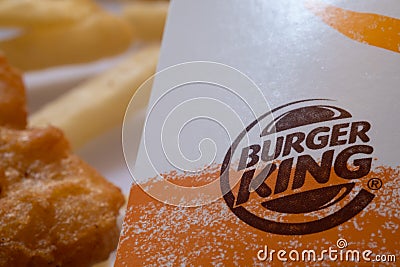 Closed up of Burger King's french fries on white background. Focus on Burger King's logo Editorial Stock Photo