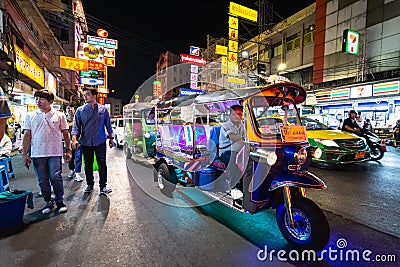 Bangkok, Thailand - March 2019: tuk-tuk taxi driver at China town night market Editorial Stock Photo